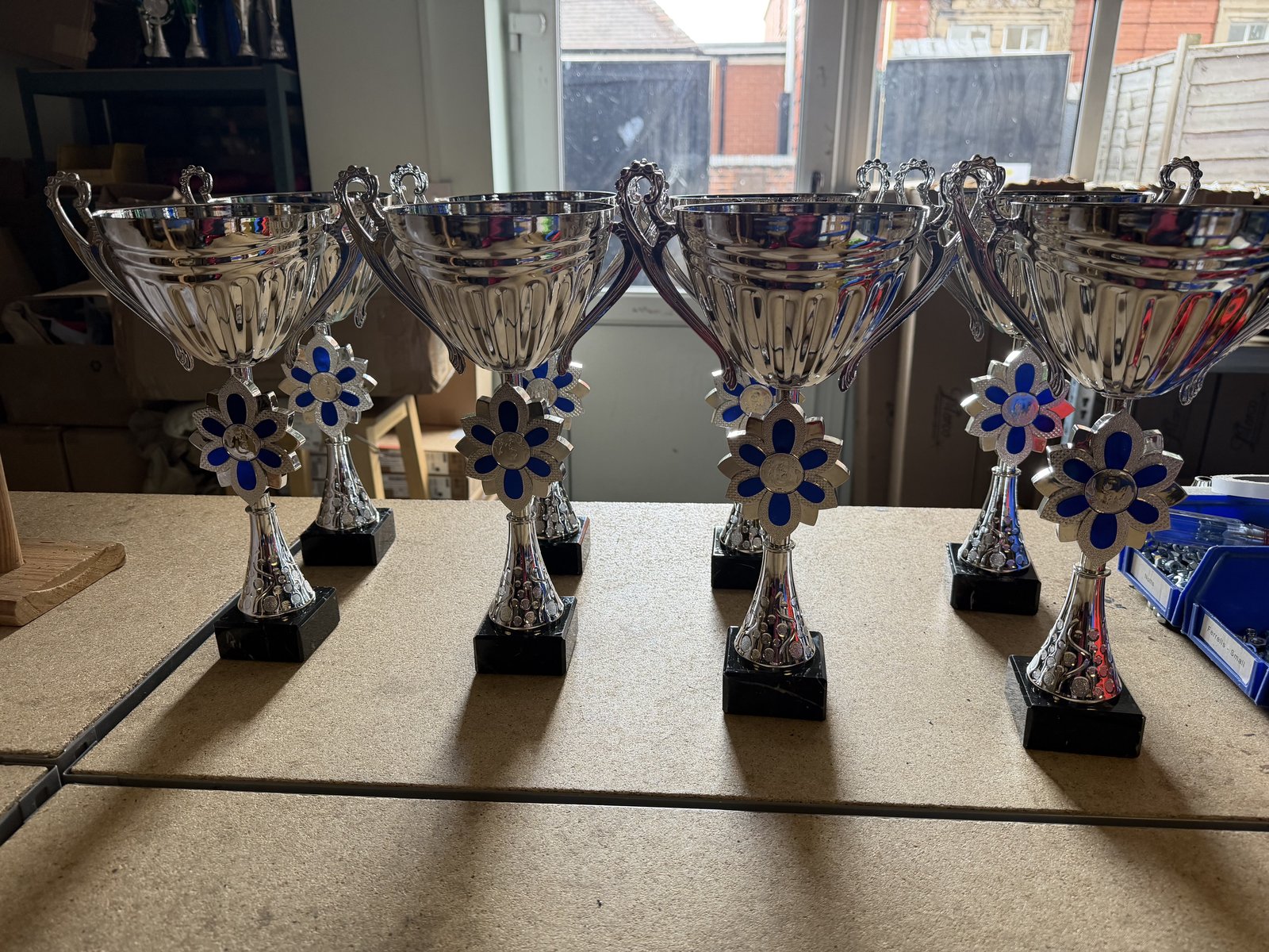 Silver presentation cups displayed in the 1st Place 4 Trophies showroom